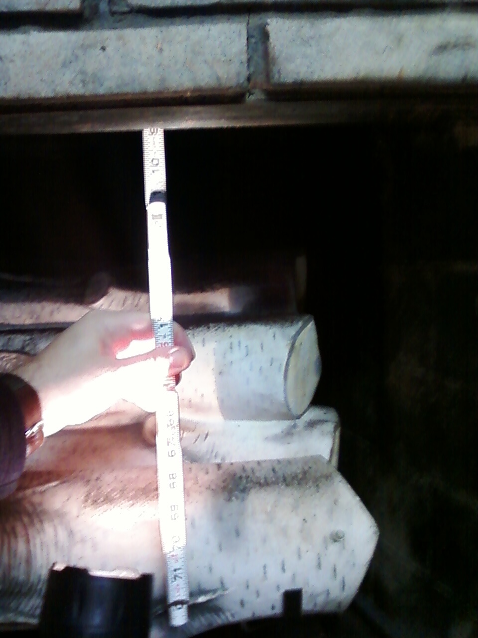 Measure fireplace lintel below damper